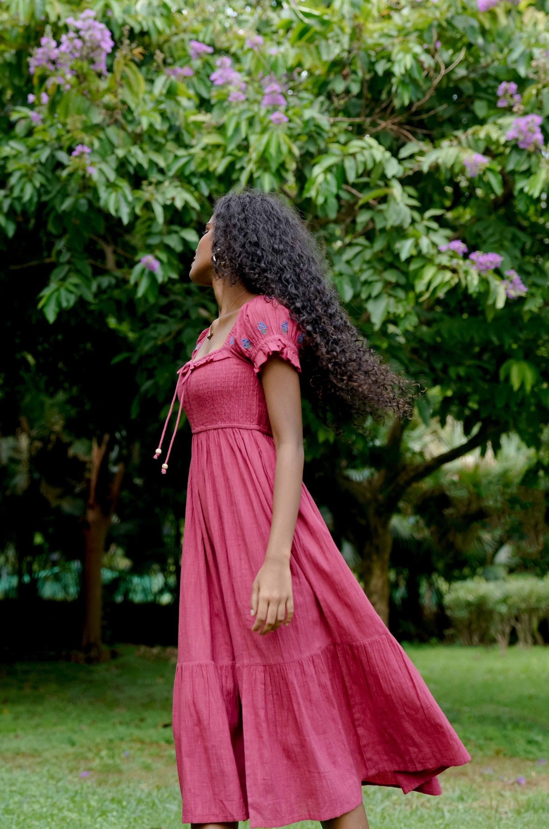 Side picture of boho style red dress with floral embrodiery 