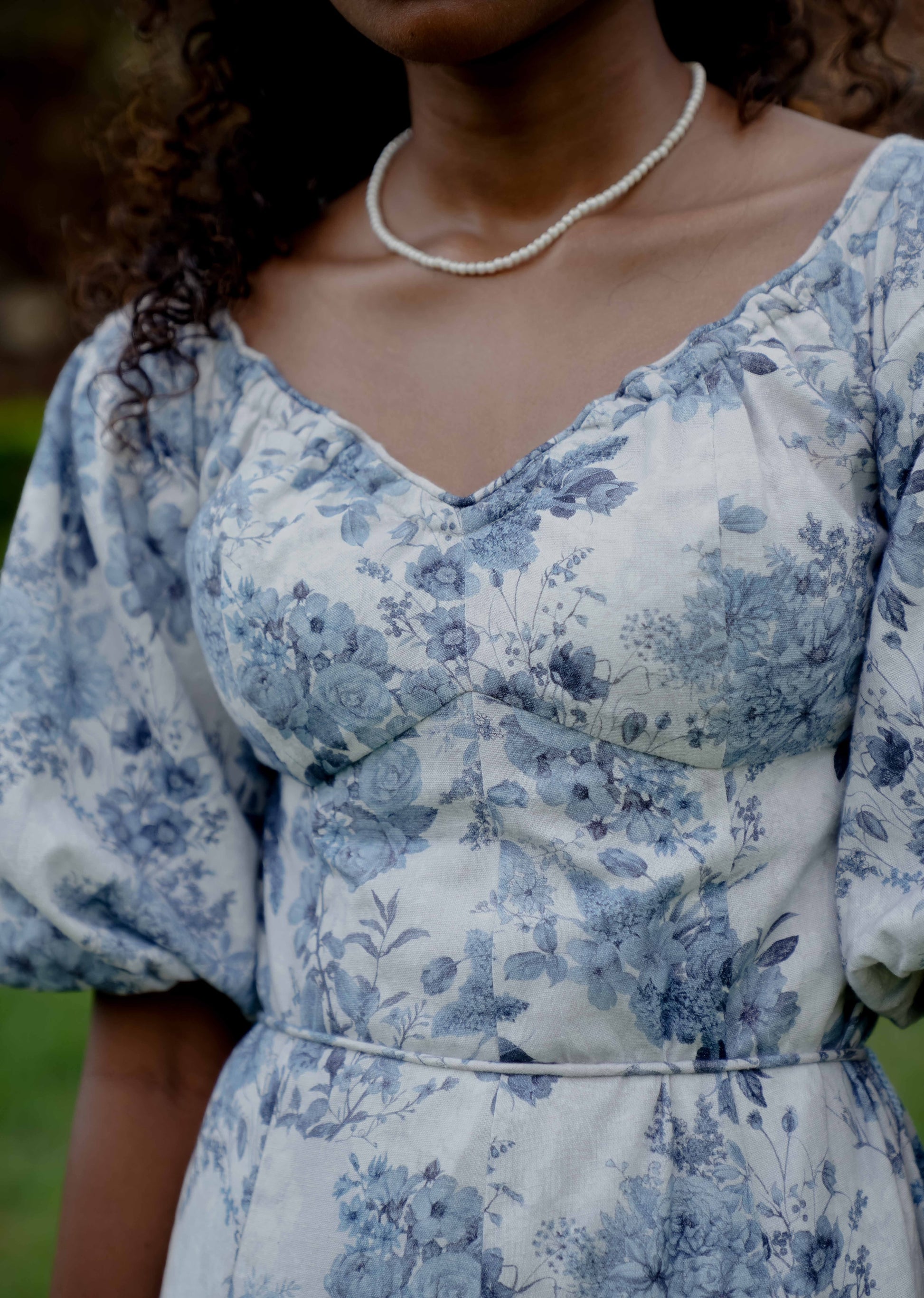 Close up picture of floral off shoulder midi dress