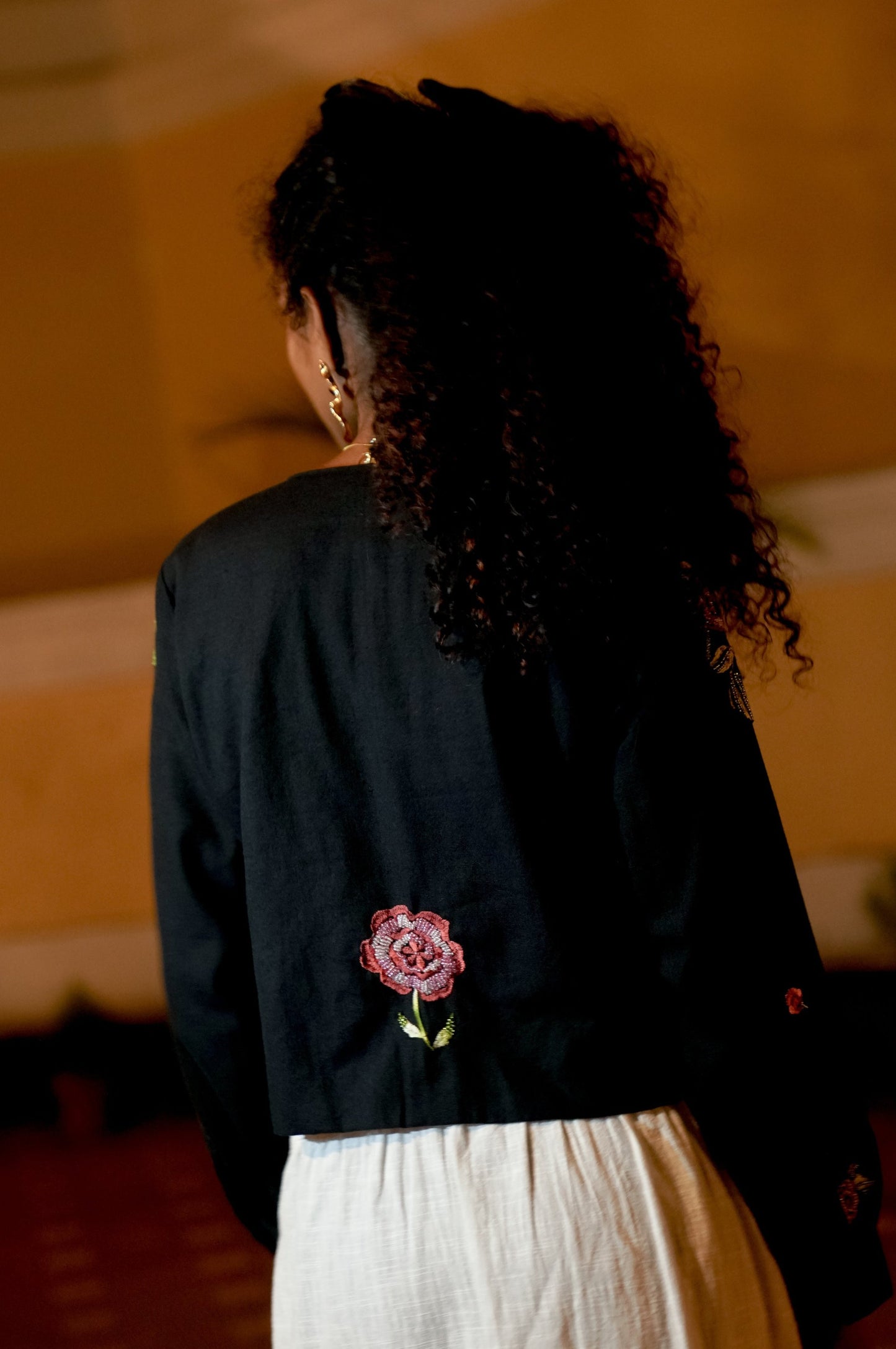 Back picture of black embroidered crop jacket