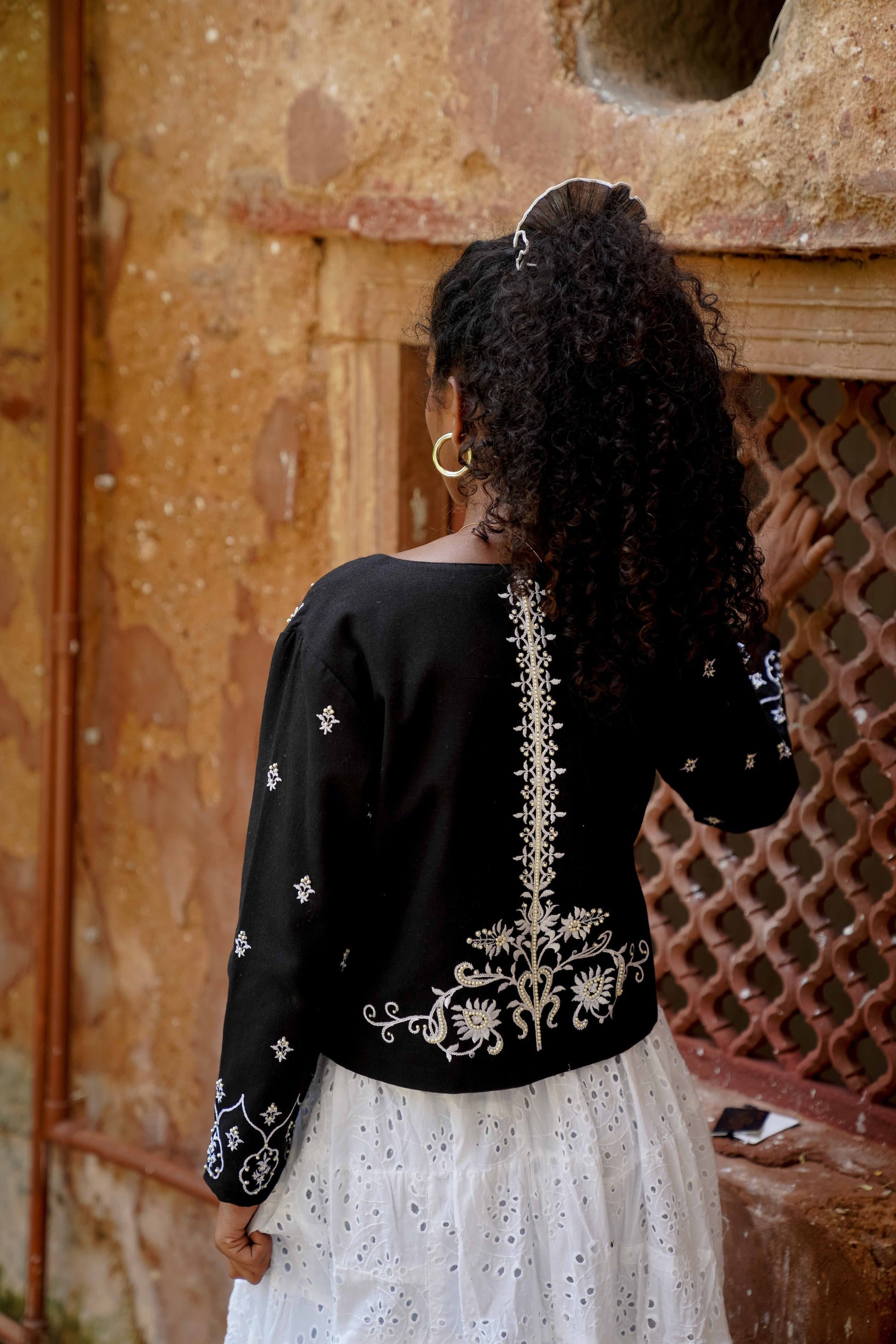 Back picture of black cropped jacket with embroidery