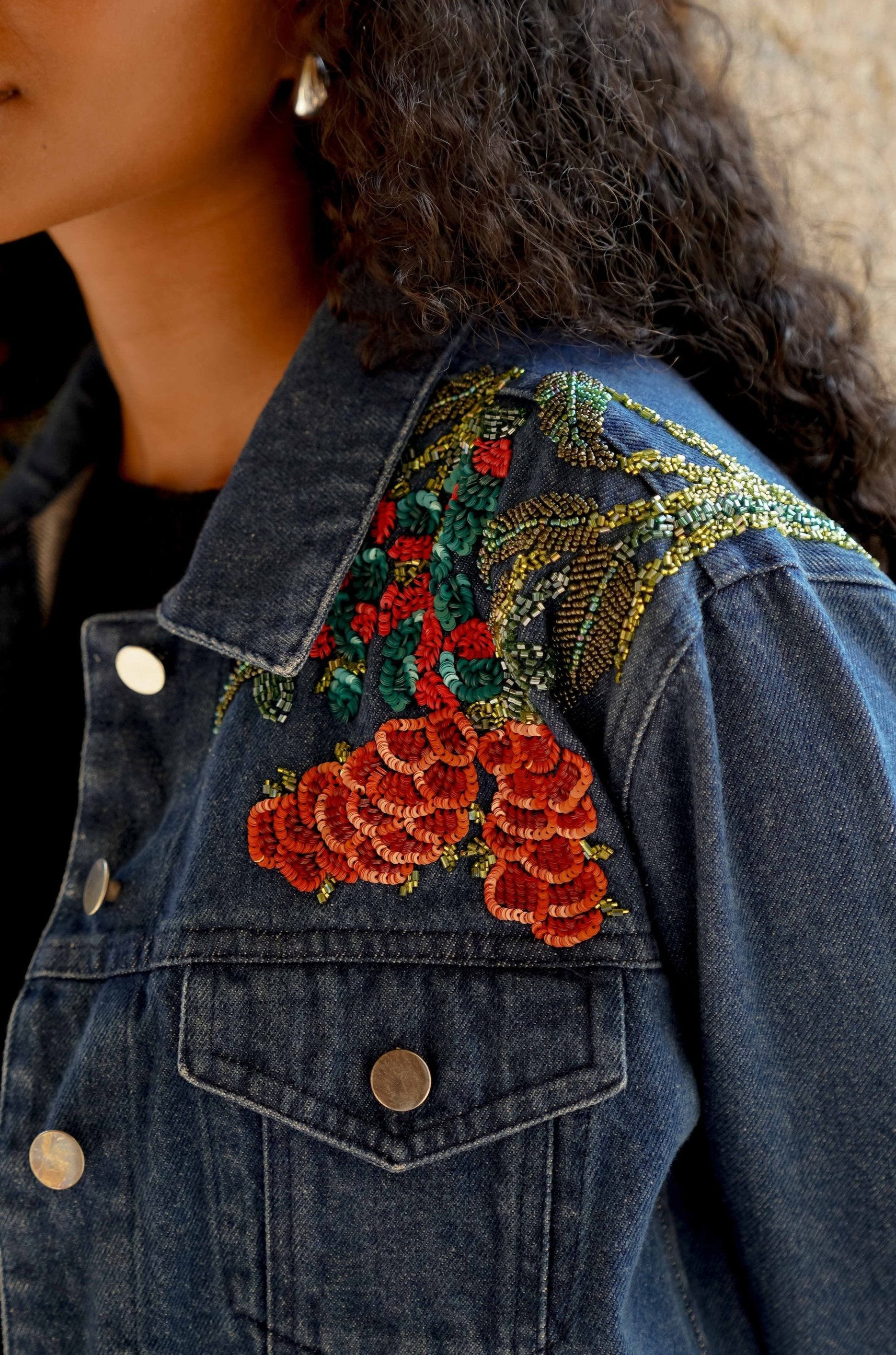 close up picture of blue cropped denim jacket