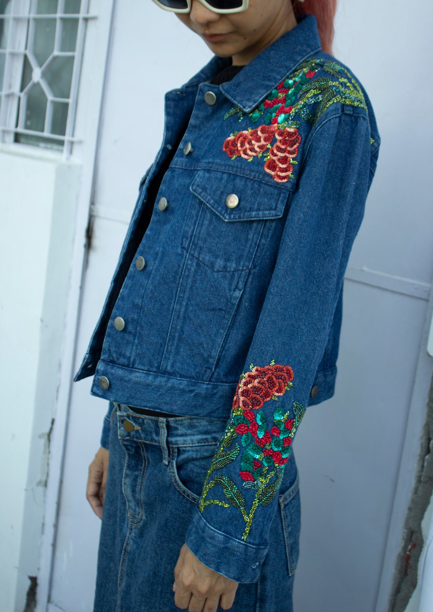 Close up of the side of blue cropped denim jacket