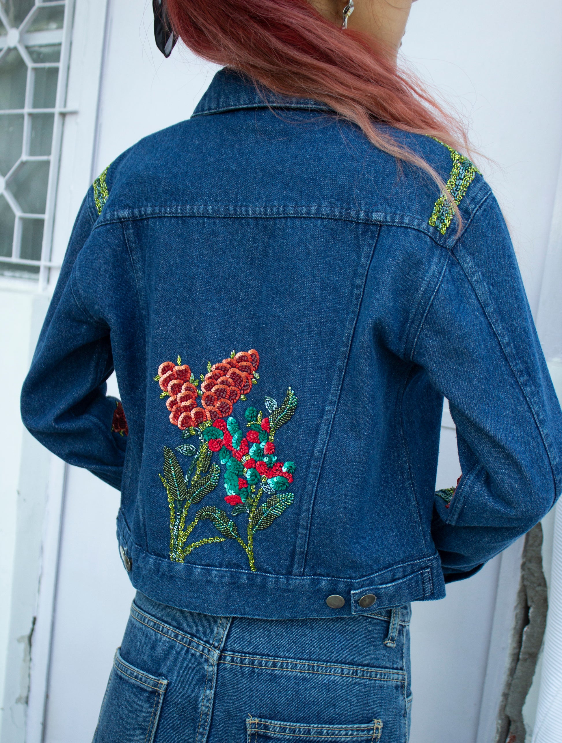 Back picture of blue cropped denim jacket