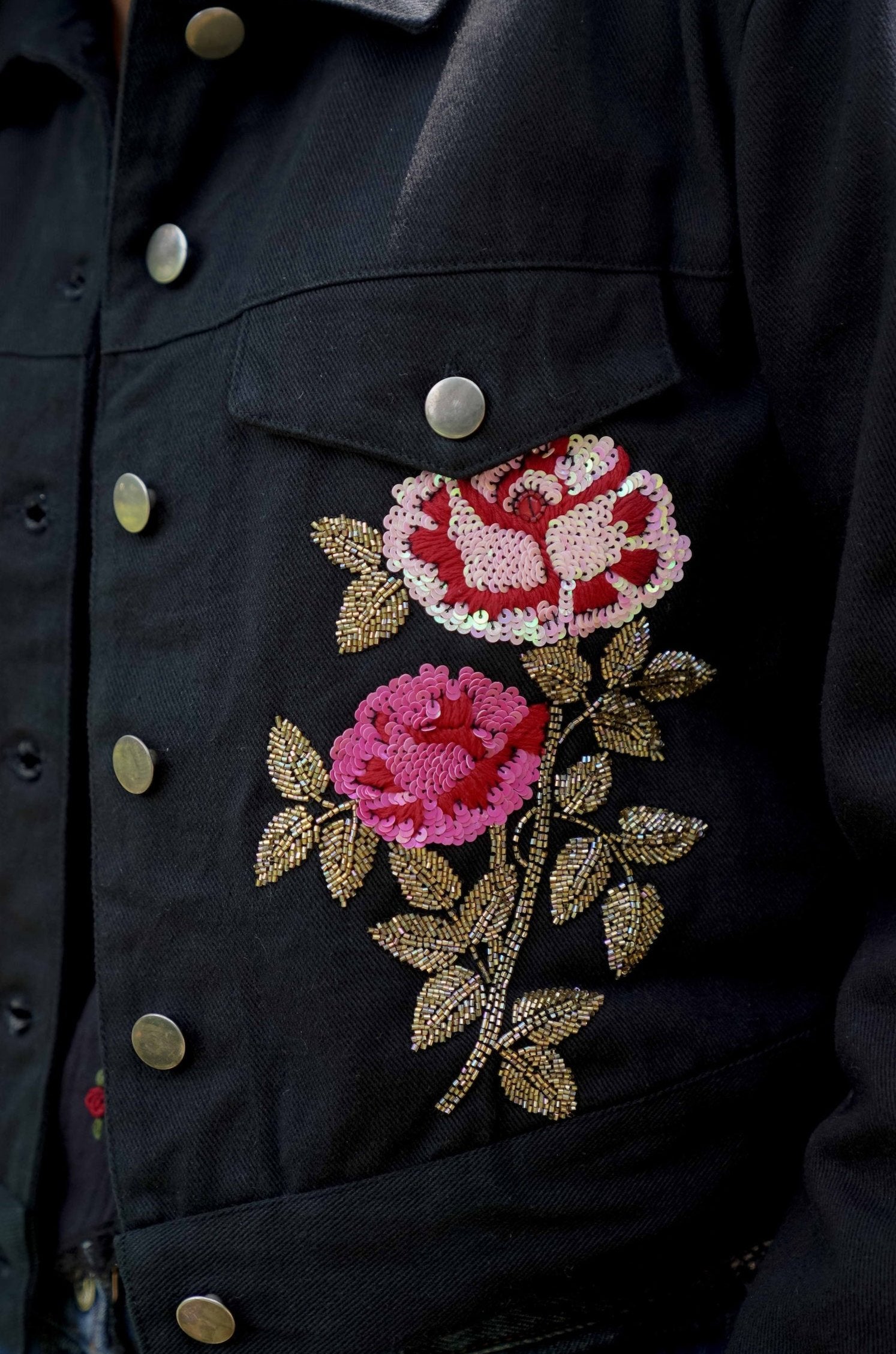 Detail picture of the embroidery on black embroidered denim jacket