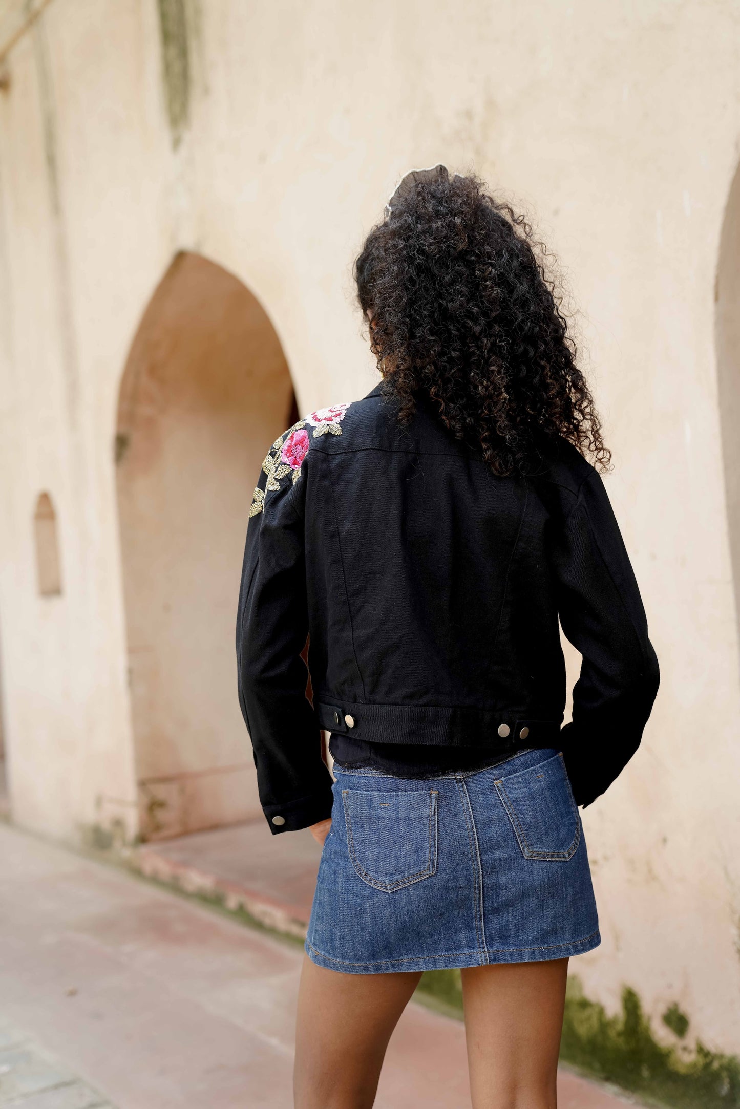 Back picture of black embroidered denim jacket