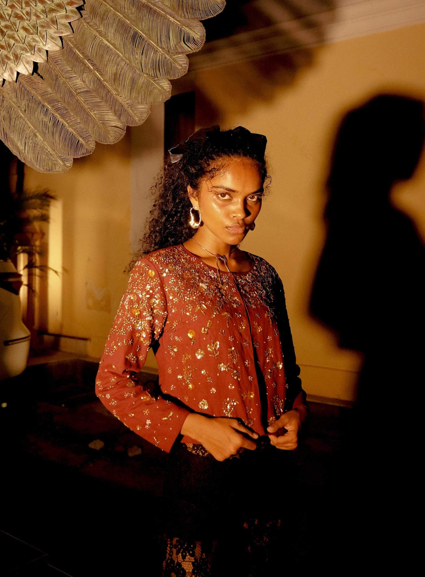 Front picture of model wearing burgundy embroidered cropped jacket