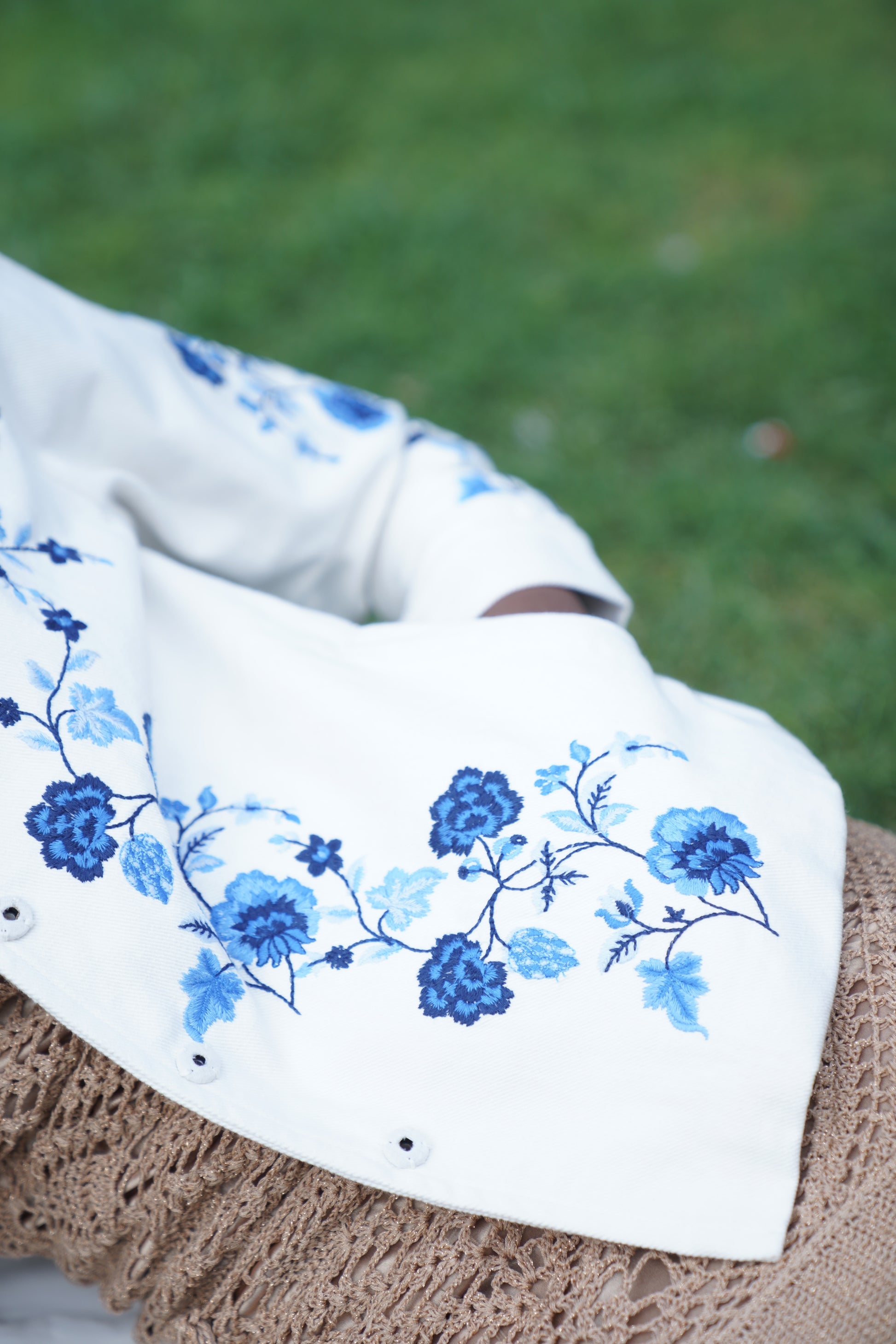 Close up detail picture of white embroidered jacket