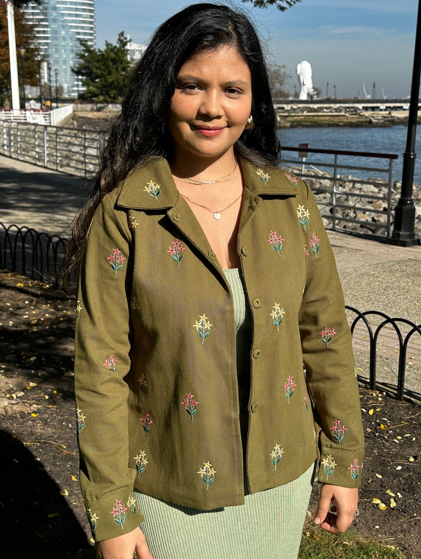 Front detail photo of olive green embroidered jacket