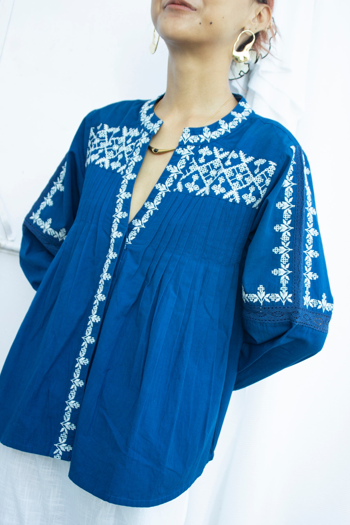 Front picture of blue and white embroidered top