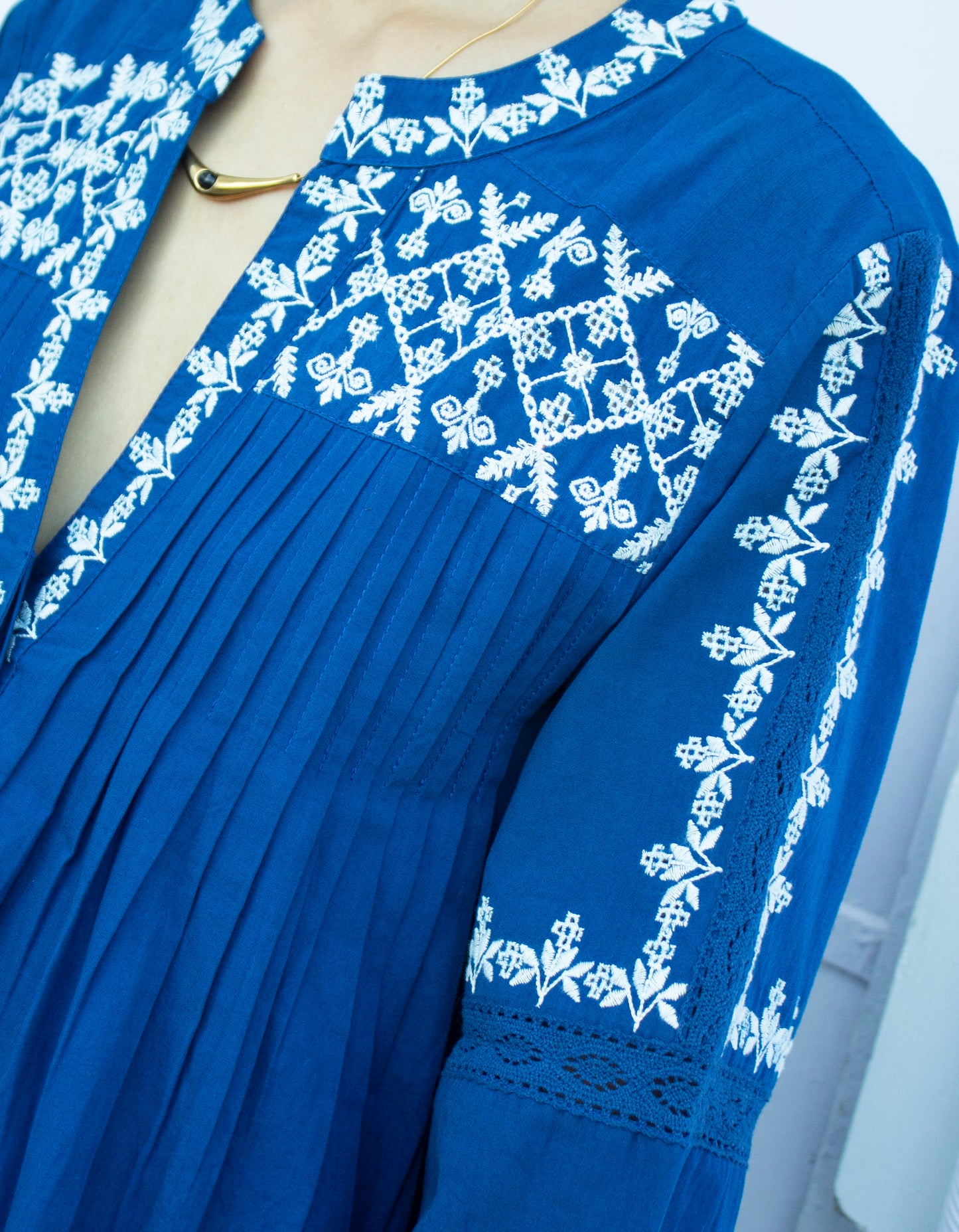 Detail picture of blue and white embroidered top where you can see the placket