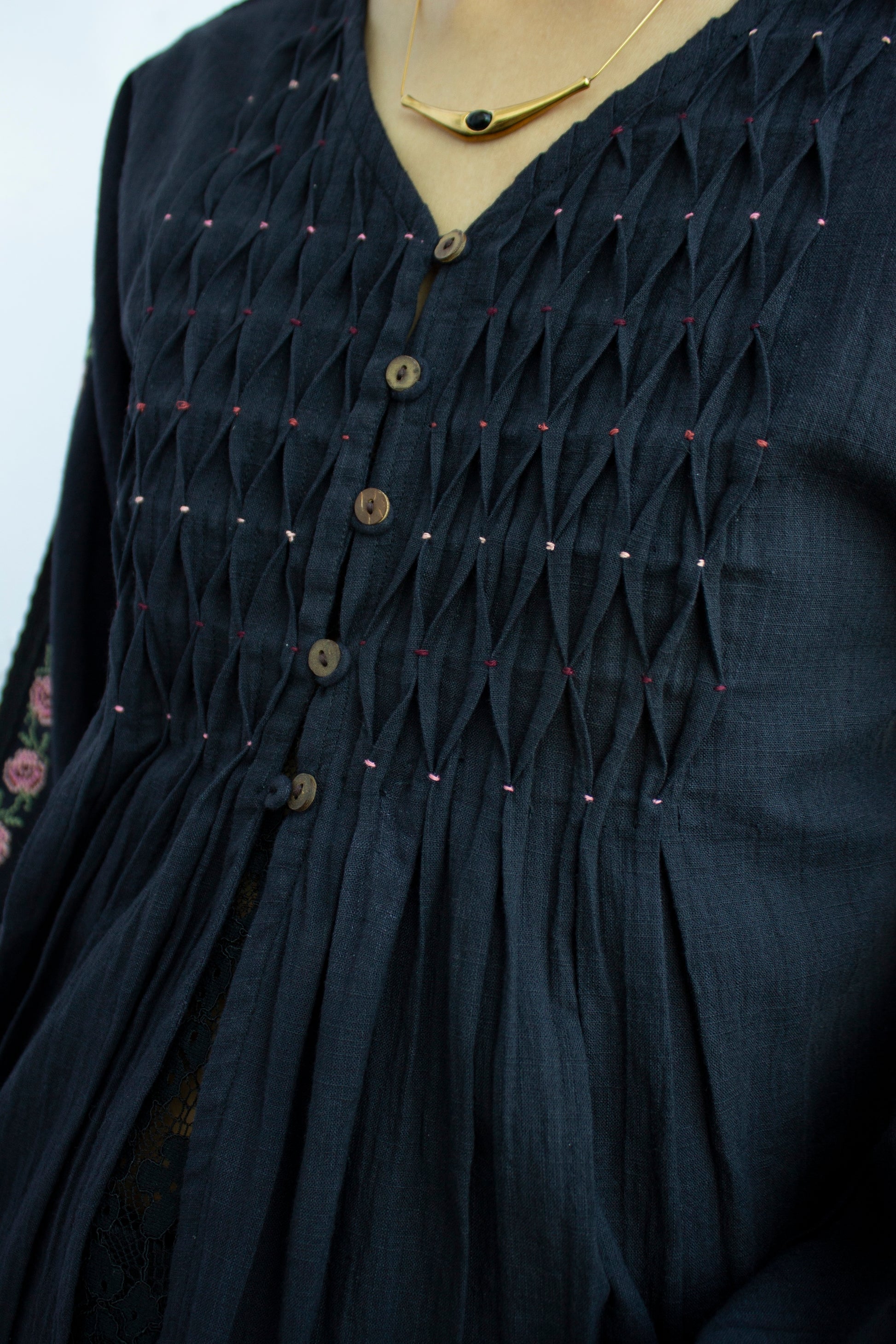 Detail picture of the pleats on black embroidered top