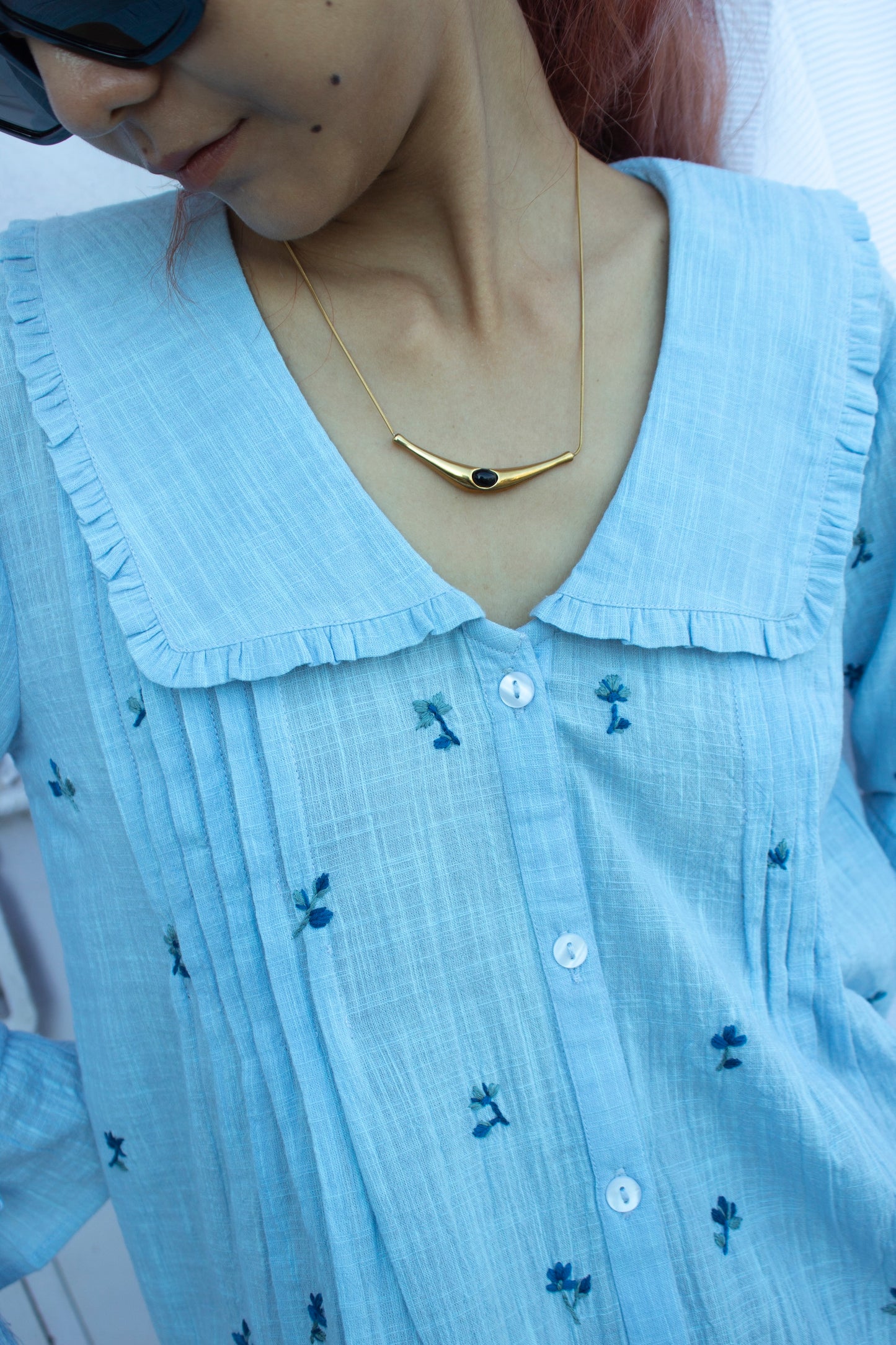 Detail picture of the collar on blue embroidered top