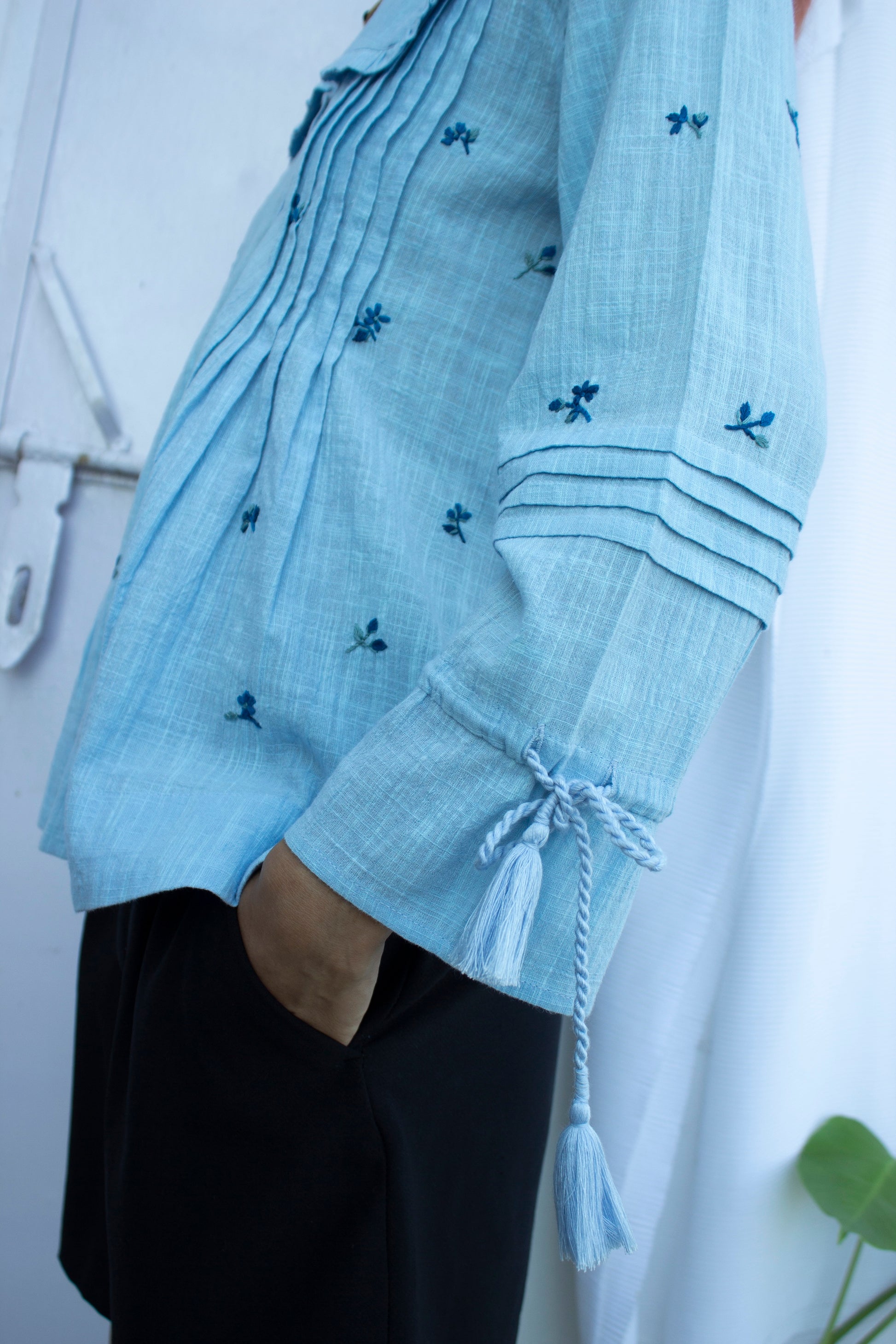 Sleeve detail picture of blue embroidered top